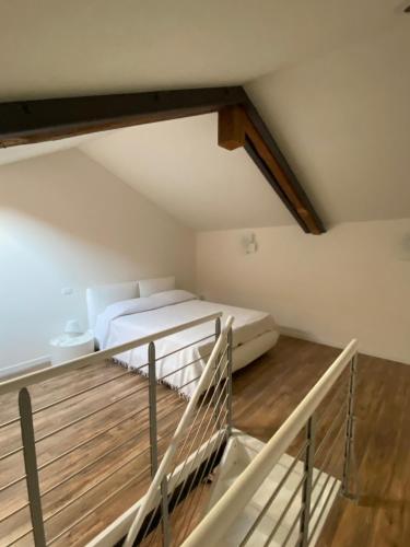 a attic bedroom with a bed and a balcony at Savorgnan 1593 in Palmanova