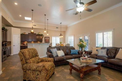 a living room with couches and a table and a kitchen at 4 bedroom gorgeous home Eastside El Paso in El Paso