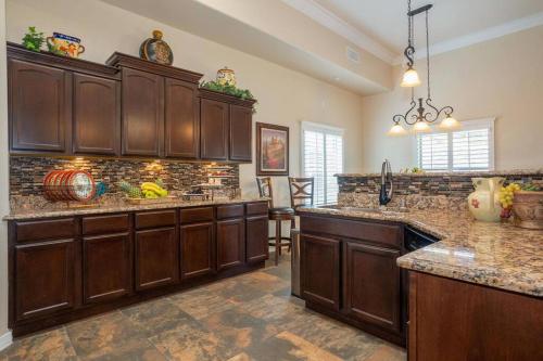 a large kitchen with wooden cabinets and granite counter tops at 4 bedroom gorgeous home Eastside El Paso in El Paso