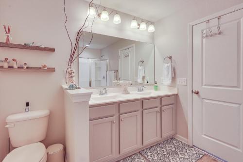 a bathroom with a sink and a toilet and a mirror at Sweet Dreamin Townhome about 7 Mi to Beach! in Wrightsville Beach