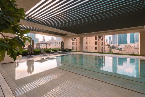 a swimming pool on the roof of a building at BURJ ROYAL-Luxurious 2 Bedrooms -DOWNTOWN-Burj & Fountain View in Dubai