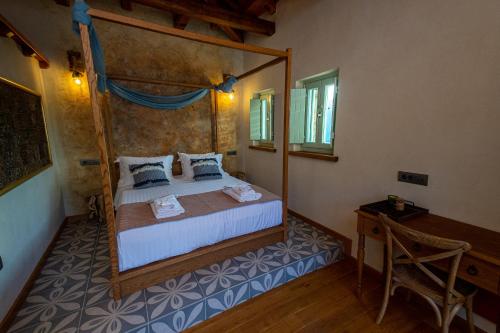 a bedroom with a bed with a wooden frame at Nostos Country House in Tsagarada