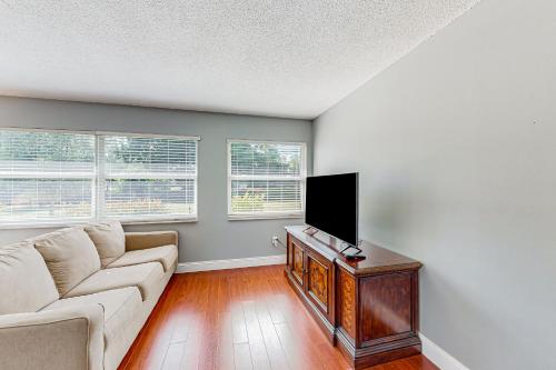 a living room with a couch and a flat screen tv at A Sunshine State of Mind in North River Shores