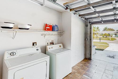 a laundry room with a washer and dryer at A Sunshine State of Mind in North River Shores