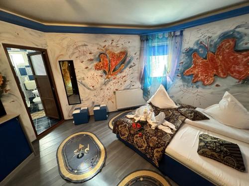 a bedroom with a fish themed wall at Pensiunea Alexandra & Diego in Predeal