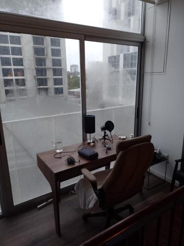 a office with a desk and a chair and a window at Lovely and Peaceful Home in Guatemala