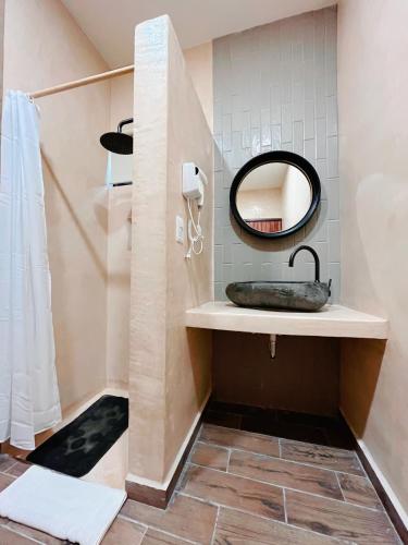 a bathroom with a sink and a mirror at Arena Apartment 2 in Holbox Island