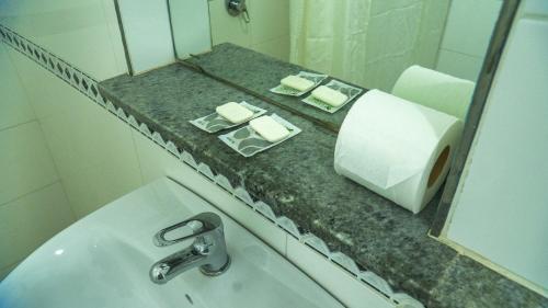 een badkamer met een wastafel en een spiegel bij Constitución Palace Hotel in Buenos Aires