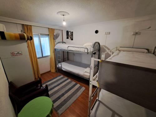 a small room with two bunk beds and a television at El Cascabel in Granada