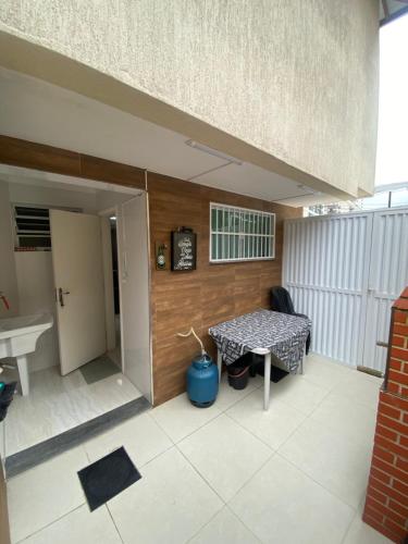 a small balcony with a table and a sink at Casa de Praia - Distância de 100 metros in Praia Grande