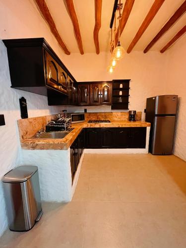 a kitchen with a sink and a refrigerator at Casa Arena Holbox! in Holbox Island