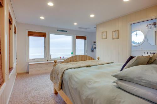 a bedroom with two beds and windows with the ocean at Dreamy Port Orford Home with Oceanfront Views in Port Orford