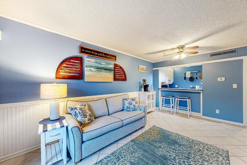 a living room with a couch and a kitchen at Playa Flor de Cana in Myrtle Beach