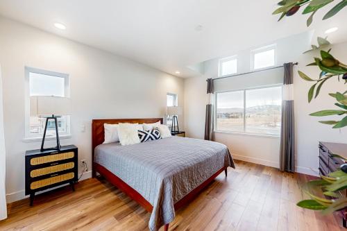 a bedroom with a bed and a large window at Mountain Sky in Granby