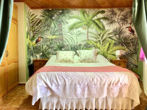 a bedroom with a bed with a tropical wallpaper at VV APARTAMENTOS ESTRELLA DEL NORTE in Icod de los Vinos