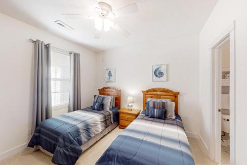a bedroom with two beds and a ceiling fan at Cypress Bay 14-204 in Little River