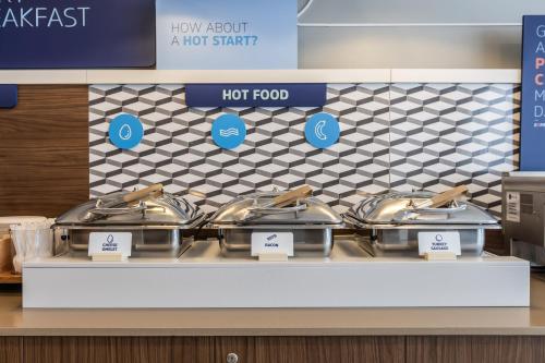 a row of pots and pans on a counter in a store at Holiday Inn Express Toronto-North York by IHG in Toronto