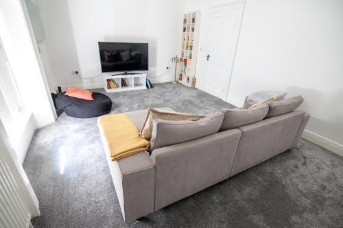 a living room with a couch and a tv at Kilpatrick Glebe in Crossabeg