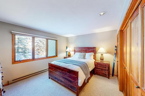 a bedroom with a large bed and a window at Riverside A02 - Riverside Chickadee in Telluride