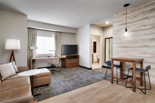 a living room with a couch and a table and a desk at Residence Inn by Marriott Vail in Vail