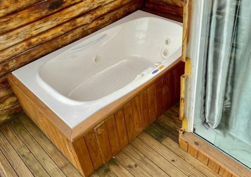 a bath tub sitting in the corner of a room at Pousada São Miguel Beach Beira Mar in Penha