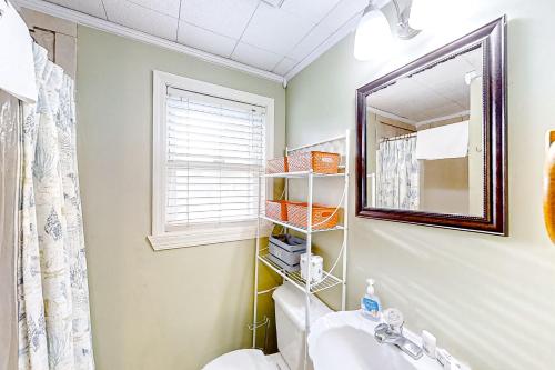 a bathroom with a sink and a mirror at Seahorse Serenity in Myrtle Beach
