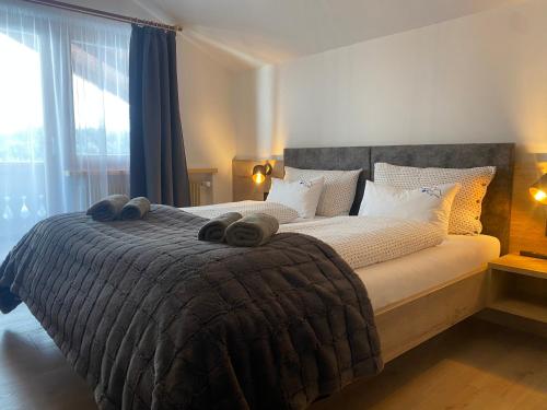 a bedroom with a large bed with towels on it at Ampio appartamento di 200mq nel cuore di Antermoia in Antermoia