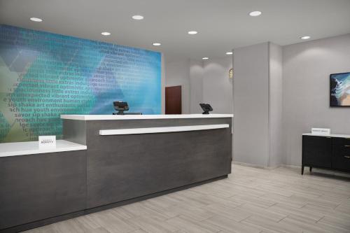 a lobby with a counter with a blue wall at SpringHill Suites by Marriott Annapolis in Annapolis