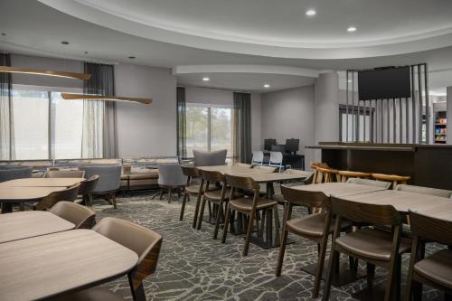 a restaurant with tables and chairs and a tv at SpringHill Suites by Marriott Annapolis in Annapolis