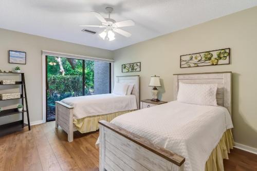 two beds in a room with a window at 3322 Fairway Oaks in Amelia Island