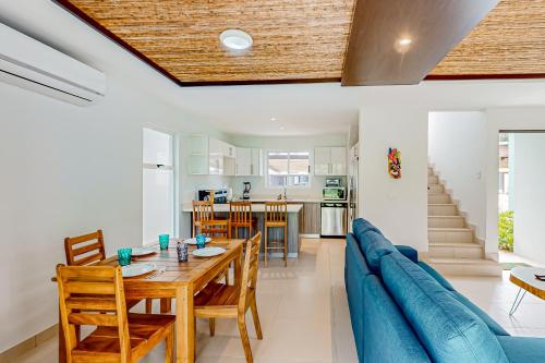 a dining room and living room with a table and chairs at Ciudad del Mar 71 in Jacó