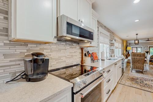 a kitchen with white cabinets and a counter top at Villa Christol in Bluffton