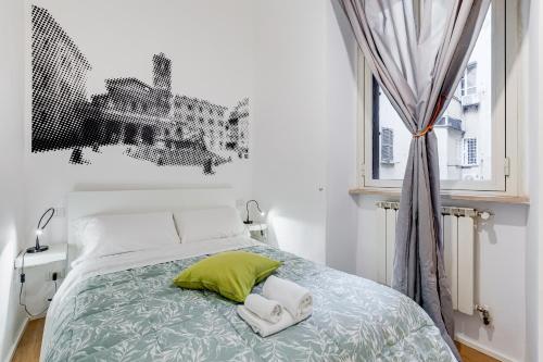 a bedroom with a bed with two towels on it at TRASTEVERE SUITE EXPERIENCE in Rome