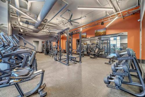 a gym with rows of treadmills and machines at Navy Nights & Scenic Feels - Sleek Studio Stay in Boise