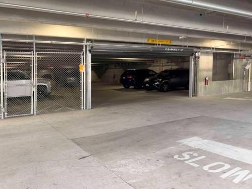 a parking garage with two cars parked in it at Navy Nights & Scenic Feels - Sleek Studio Stay in Boise
