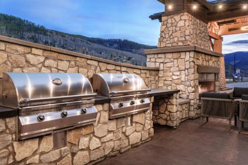 a patio with a stone wall with two stove tops at Residence Inn by Marriott Vail in Vail