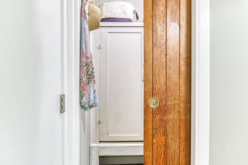 a door to a cabinet with a hat on top at Ferry Viewer Cottage, Unit 1 in Point Roberts