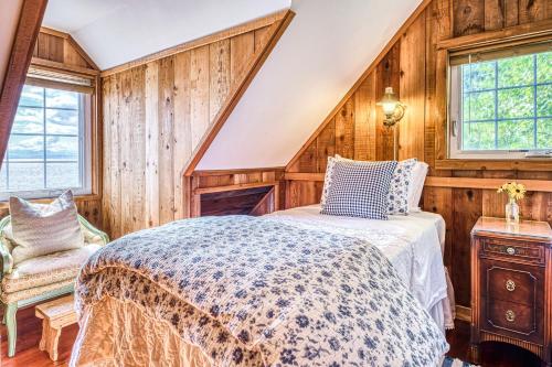 a bedroom with a bed in a room with wooden walls at Ferry Viewer Cottage, Unit 1 in Point Roberts