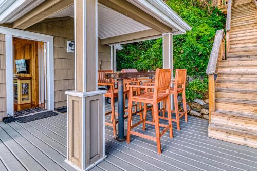 a wooden deck with a table and chairs at Ferry Viewer Cottage, Unit 1 in Point Roberts