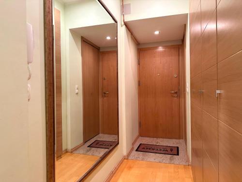 a bathroom with a mirror and a walk in shower at Apartament z widokiem na stary rynek in Wejherowo