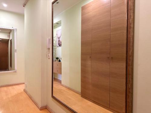 a large wooden closet in a room with a mirror at Apartament z widokiem na stary rynek in Wejherowo