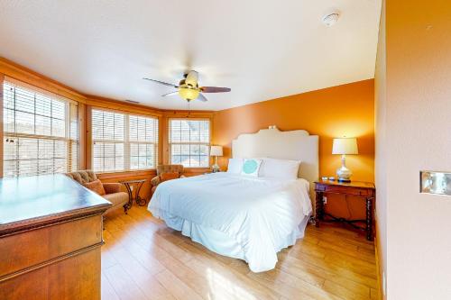 a bedroom with a white bed and a desk at Flagstaff Fantasy - Main House in Flagstaff