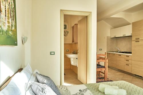 a bedroom with a bed and a bathroom with a sink at Lovely Studio Apartment ln Centre SantaMaria in Santa Maria