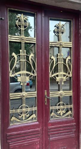a red door with two glass windows on a building at Apartment Romana in Sarajevo