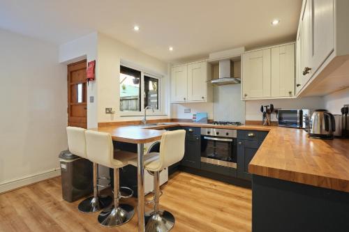 a kitchen with a table and some chairs in it at Cottage Cross by YourStays in Macclesfield