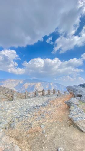 a stone wall on the side of a mountain at Al khitaym guest house in Sa‘ab Banī Khamīs