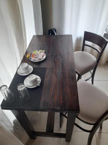 a wooden table with a plate of food on it at Los Ancares Resort in Mina Clavero