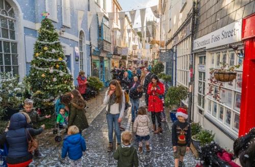 Eine Gruppe von Menschen, die mit einem Weihnachtsbaum die Straße entlang gehen in der Unterkunft Nancie's Place - DARTMOUTH TOWN CENTER with PRIVATE PARKING - A Traditional Georgian PRIVATE DUPLEX APARTMENT - BEAUTIFULLY REFURBISHED - TWO BEDROOMS, BATHROOM, KITCHEN and LOUNGE DINER in Dartmouth