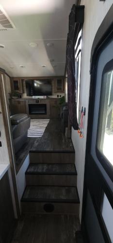 a room with stairs in an rv with a window at So "Time to Wander" A pet friendly beach retreat in Fort Myers