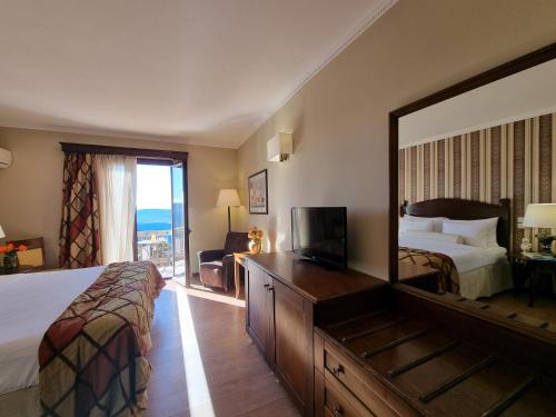 a hotel room with a bed and a large mirror at Likoria Hotel in Arachova